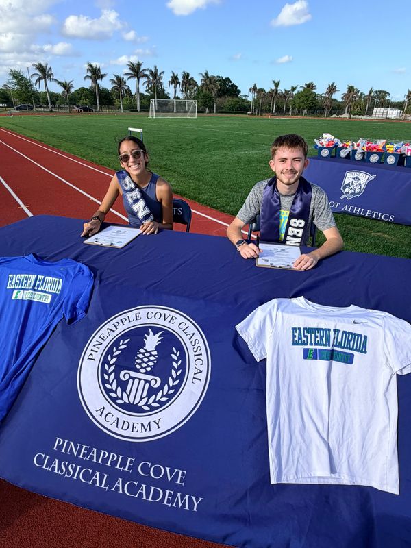 Ivonne Granados-Garcia and Logan Saunders sign to run cross country at Eastern Florida State College following a ceremony on April 14, 2026, at Pineapple Cove Academy.