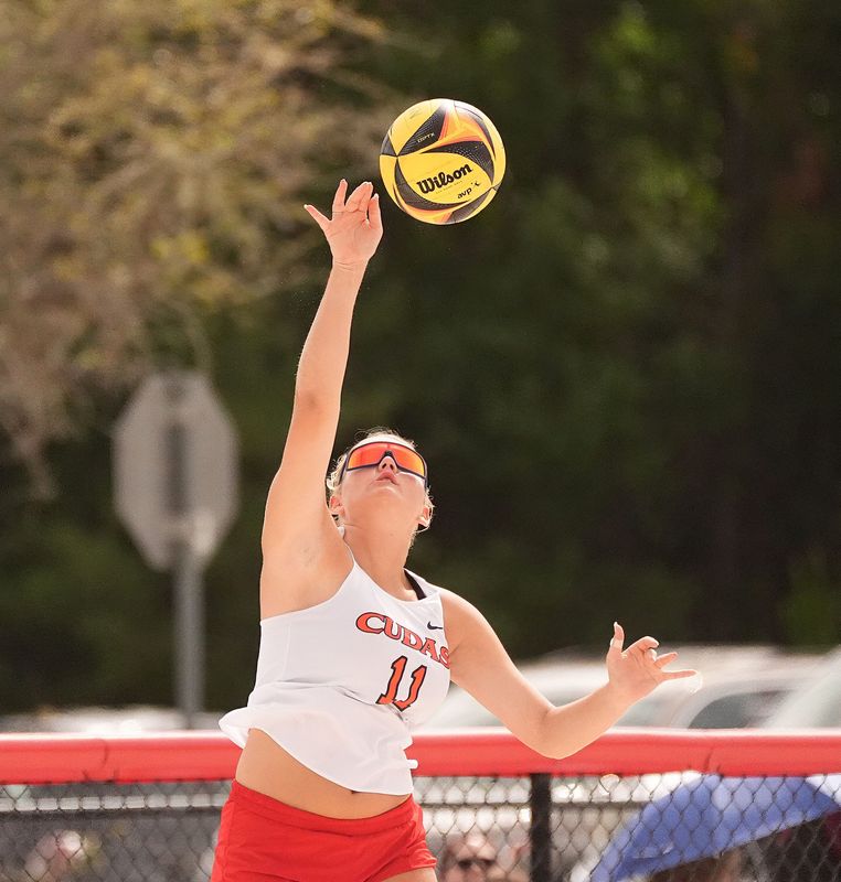 New Smyrna Beach’s Savannah Toler (11) serves the ball during the Region 2-2A beach volleyball quarterfinals against North Marion on April 27, 2026, at New Smyrna Beach High School.