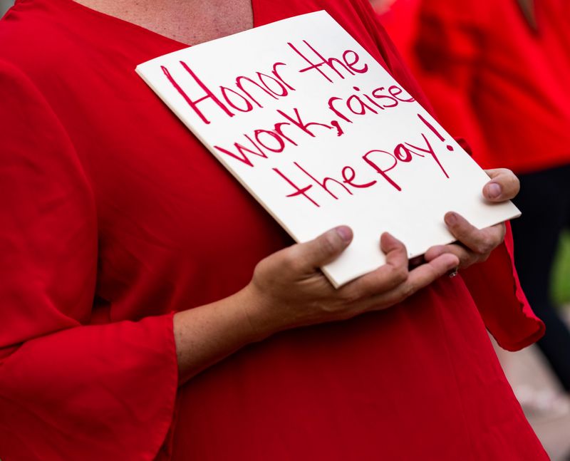 Signs made by Collier County educators are seen as they hold a rally at the Collier County Public Schools Admin Center in Naples, Fla., on Monday, April 27, 2026. The attendees were originally there to attend the public hearing to discuss the impasse with the Collier County Education Association and school board. It was canceled due to a board member having a medical emergency, according to the CCPS website.