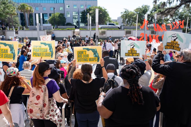 Activists gather outside the North Portico at the Florida Capitol to protest the proposed redistricting map Tuesday, April 28, 2026.
