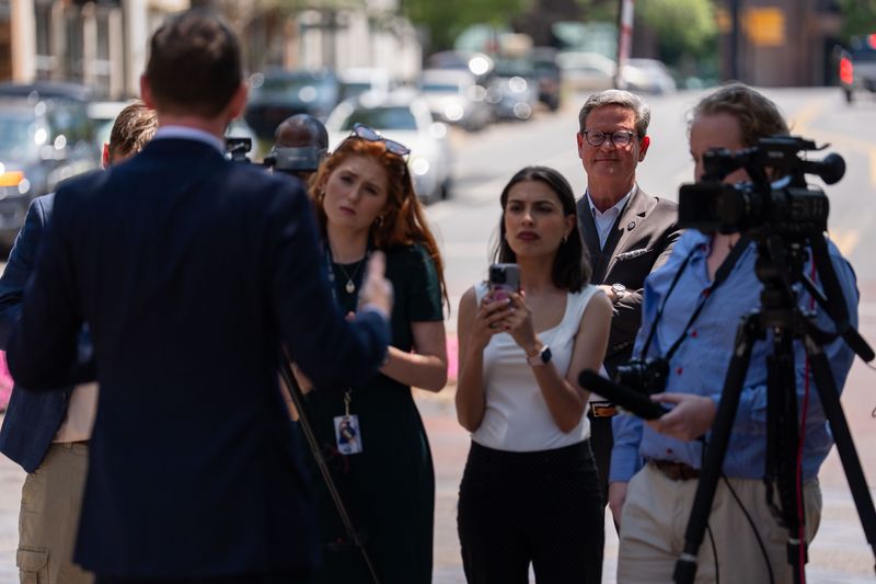 Mayor John Dailey listens as City Commissioner Jeremy Matlow speaks to the media regarding the resignation of City Manager Reese Goad on Tuesday, April 28, 2026.