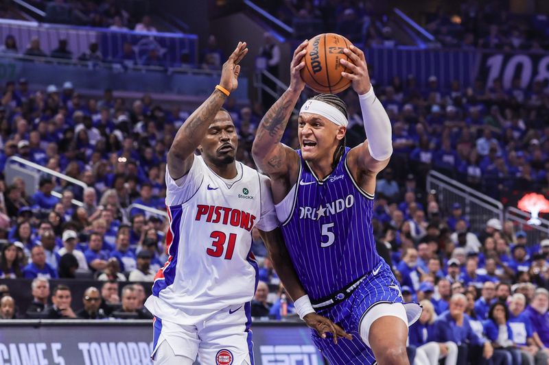 Apr 27, 2026; Orlando, Florida, USA; Orlando Magic forward Paolo Banchero (5) goes to the basket against Detroit Pistons guard Javonte Green (31) during the second half during game four of the first round of the 2026 NBA Playoffs at Kia Center.