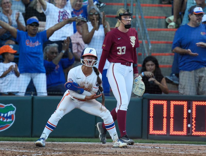 Florida infielder Gabi Comia (10) celebrates stealing home during a NCAA softball game at Katie Seashole Pressly Stadium in Gainesville, FL on Tuesday, April 28, 2026. [Alan Youngblood/Gainesville Sun]
