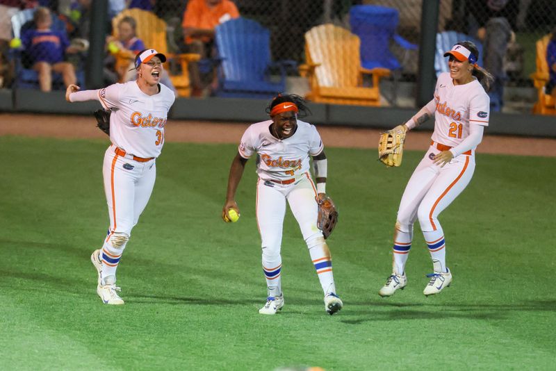 Florida outfielder Townsen Thomas (44), center, celebrates making the winning out against Florida Stat with Florida infielder Kenleigh Cahalan (31) and Florida outfielder Taylor Shumaker (21) during a NCAA softball game at Katie Seashole Pressly Stadium in Gainesville, FL on Tuesday, April 28, 2026. [Alan Youngblood/Gainesville Sun]