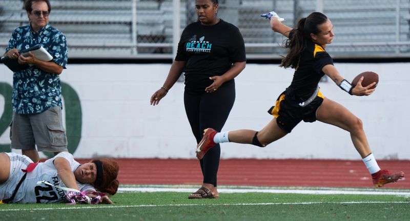 Lila Dinkel, the quarterback for the Bishop Verot flag football team runs the ball during a quarterfinal playoff game against Jensen Beach at Fort Myers High School on Tuesday, April 28, 2026. Bishop Verot won 21-0.