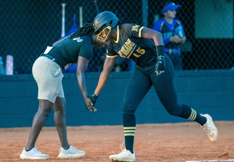 Fort Meade's Cailynn Johnson is contratulated as she rounds third base after hitting a home run against Marathon on Tuesday in the Rural-8 district semifinals.