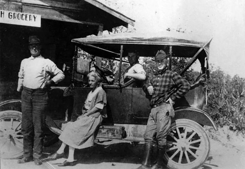 This vintage photograph captures a scene from the early 20th century at Bonita Cash Grocery in Bonita Springs.