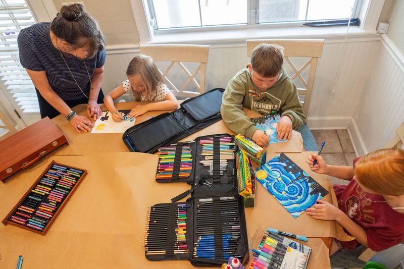 Tara Whichello, a traveling art teacher, works with a small group of homeschool students on a piece of impressionism art, inspired by artist Vincent Van Gogh, Monday, April 27, 2026.
