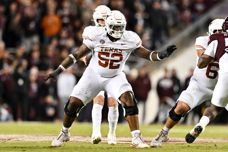 Nov 30, 2024; College Station, Texas, USA; Texas Longhorns offensive lineman DJ Campbell (52) blocks during the second half against the Texas A&M Aggies. The Longhorns defeated the Aggies 17-7 at Kyle Field. Mandatory Credit: Maria Lysaker-Imagn Images