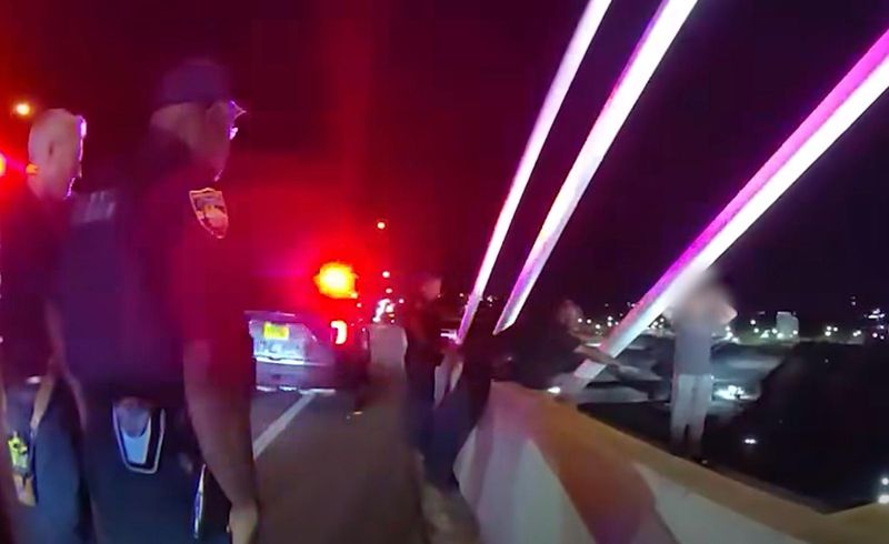 Officer Antonio Richardson of the Jacksonville Sheriff's Office extends a hand to a suicidal man on the Dames Point bridge.