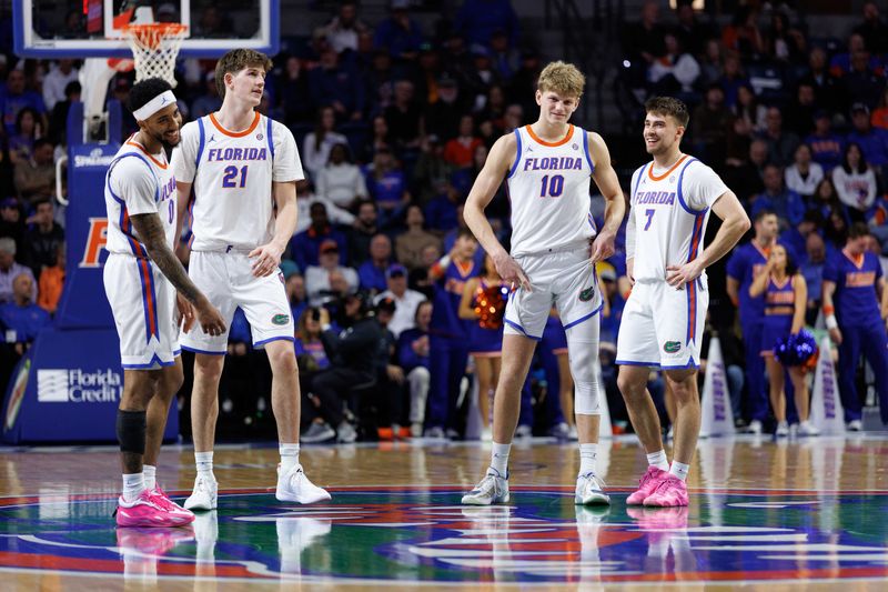 Jan 20, 2026; Gainesville, Florida, USA; Florida Gators guard Boogie Fland (0), Florida Gators forward Alex Condon (21), Florida Gators forward Thomas Haugh (10) and Florida Gators guard Urban Klavzar (7) smile during a free throw against the Louisiana State Tigers during the second half at Exactech Arena at the Stephen C. O'Connell Center. Mandatory Credit: Matt Pendleton-Imagn Images