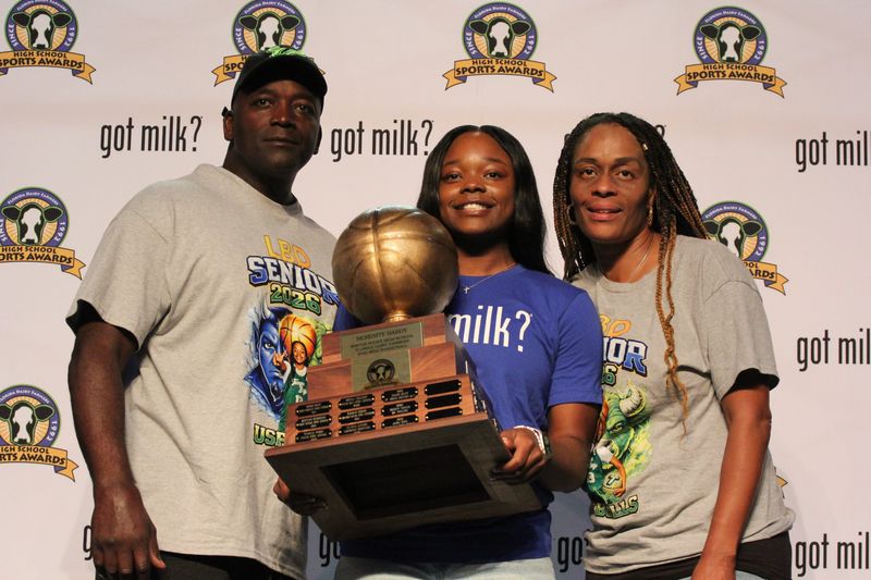 Surrounded by Winter Haven state champions, administrators, teammates and family, including father Roger Hardy and her mother Felicia, four-time Player of the Year Serenity Hardy (Got Milk shirt) is awarded the Miss Basketball award Wednesday, April 29th, 2026, at Winter Haven High School.
