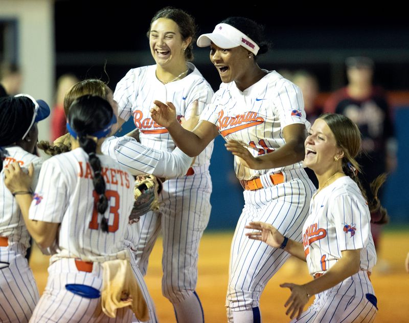 Bartow's Mia Gomez (6), Bailee Ellis (11) and Emma Huffman (1) celebrate with their teammates after defeating Bloomingdale to clinch the Class 6A, District 6 title.