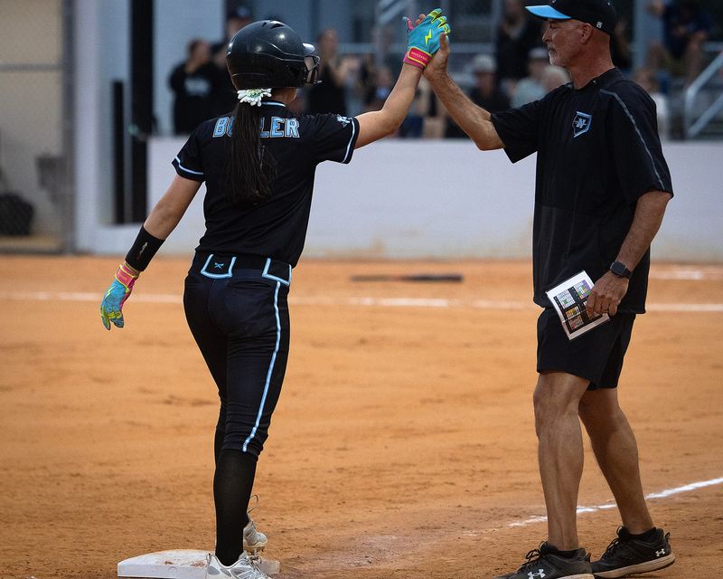 North Bay Haven's Shasta Butler receives congratulations from Butch Bernard, her coach, after smacking an RBI triple during their Class 2A District 1 championship game against Bozeman in Panama City, Florida, April 29, 2026. North Bay Haven would go on to win the game 13-3. (Tyler Orsburn/Panama City News Herald)