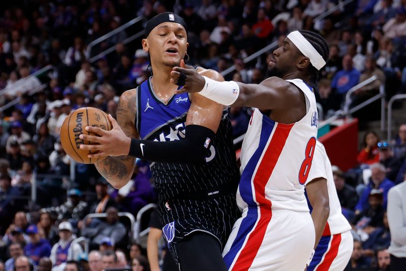 Apr 29, 2026; Detroit, Michigan, USA; Orlando Magic forward Paolo Banchero (5) is defended by Detroit Pistons guard Caris LeVert (8) in the first half during game five of the first round of the 2026 NBA Playoffs at Little Caesars Arena.