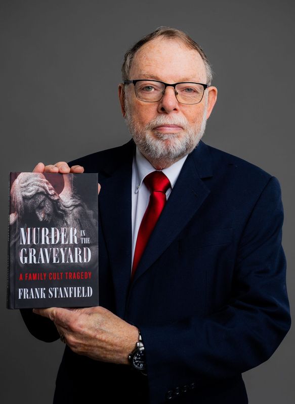 Frank Stanfield with his latest book, "Murder in the Graveyard."