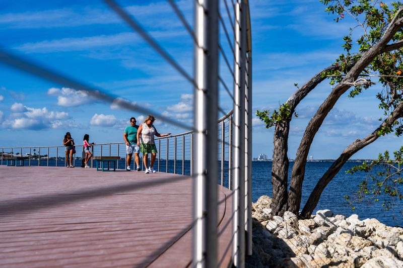 People check out the views from the boardwalk's overlook during the reopening of Jaycee Park in Cape Coral, Fla., on Thursday, April 30, 2026. The park underwent a $12 million renovation that took more than a year to complete.