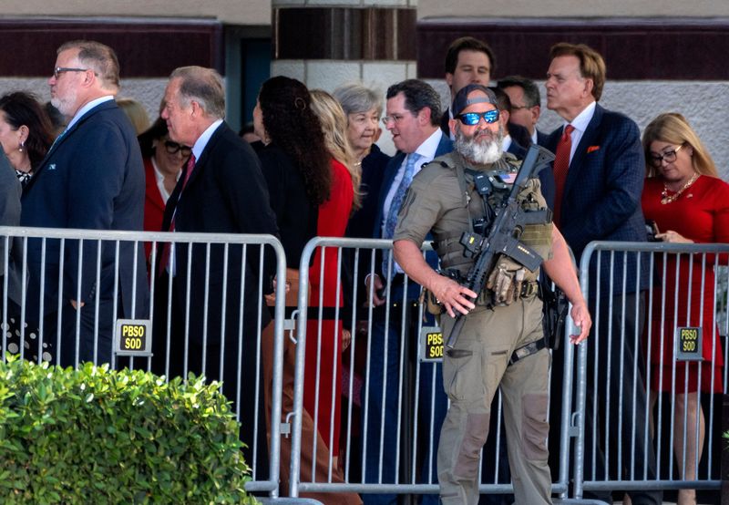 A PBSO SWAT team member stands guard as guests arrive to go through security before President Donald Trump speaks to the Forum Club of the Palm Beaches at the Kravis Center on May 1, 2026, in West Palm Beach, Florida.