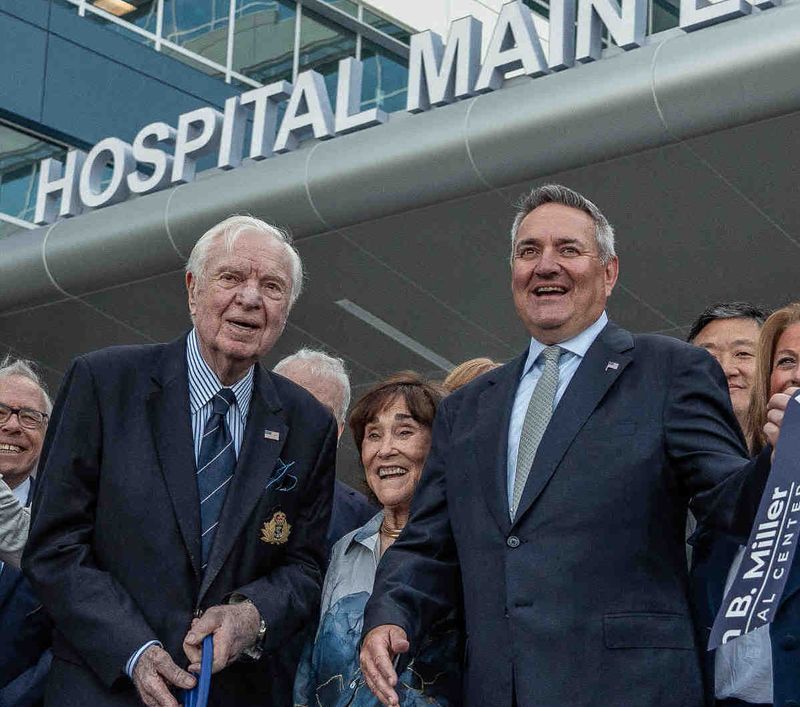 Alan B. Miller, with ceremonial scissors, stands with his wife Jill and son Mark D. Miller at the public unveiling and ribbon cutting ceremony of the Alan B. Miller Medical Center in Palm Beach Gardens, Fla., on April 29, 2025. It is the newest facility for Universal Health Services, founded by Miller in 1978.