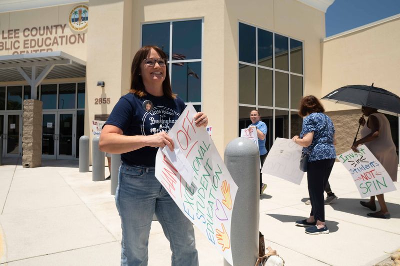 Parent Katie Peterson protested outside the Lee County School District headquarters before a press conference with the Lee County Superintendent Denise Carlin and Education Commissioner Anastasios Kamoutsas Friday, May 1, 2026.