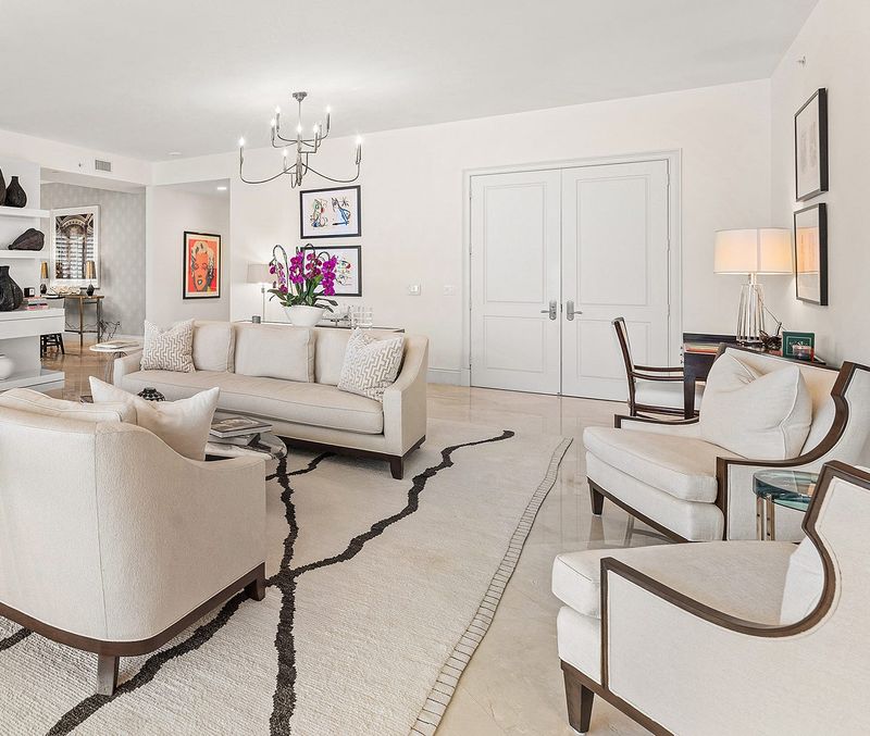 The apartment's double front doors open directly into the living area from a private elevator foyer.