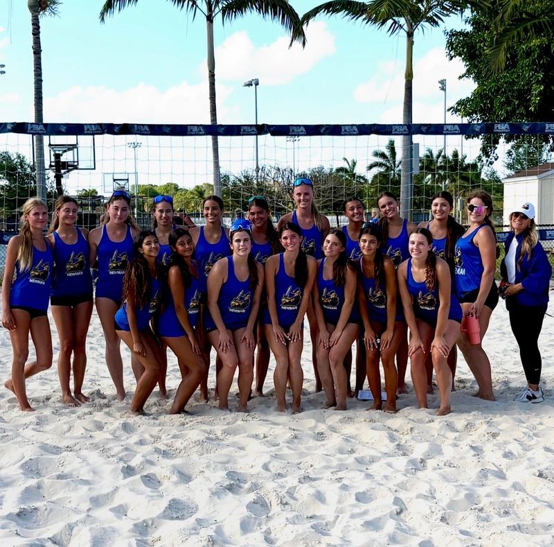 Cardinal Newman's beach volleyball team takes a celebratory photo following their match.