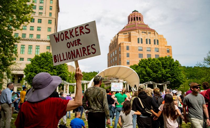 People gather in Pack Square Park during a May Day rally organized by Buncombe Over Billionaires in Asheville on May 1, 2026.