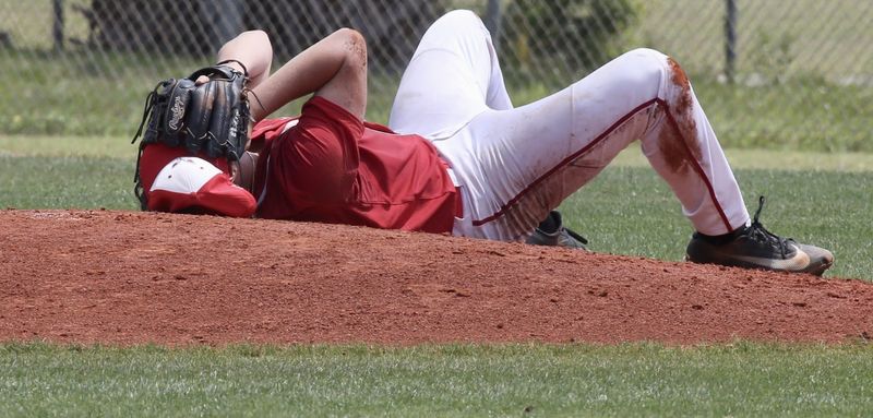 Vero Beach High pitcher Brandon Walker covers his face after getting hit with a batted ball in the face against Harmony High in Game 2 of the best-of-3 series in the Class 7A-Region 3 semifinals Saturday at Vero Beach High.