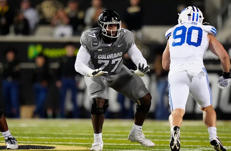 Sep 27, 2025; Boulder, Colorado, USA; Colorado Buffaloes offensive tackle Jordan Seaton (77) pass protects on Brigham Young Cougars defensive end Hunter Clegg (90) in the second quarter at Folsom Field. Mandatory Credit: Ron Chenoy-Imagn Images