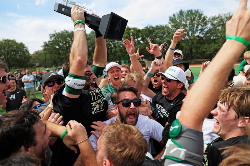 Jacksonville Dolphins midfielder Charlie DiGennaro (32) hoists the trophy while the team celebrates after the game of the ASUN Men’s Lacrosse Championship at Rock Stadium, Sunday, May 3, 2026, in Jacksonville, Fla. Jacksonville defeated Air Force 16-7, capturing the ASUN title and an automatic bid to the NCAA Tournament. [Corey Perrine/Florida Times-Union]