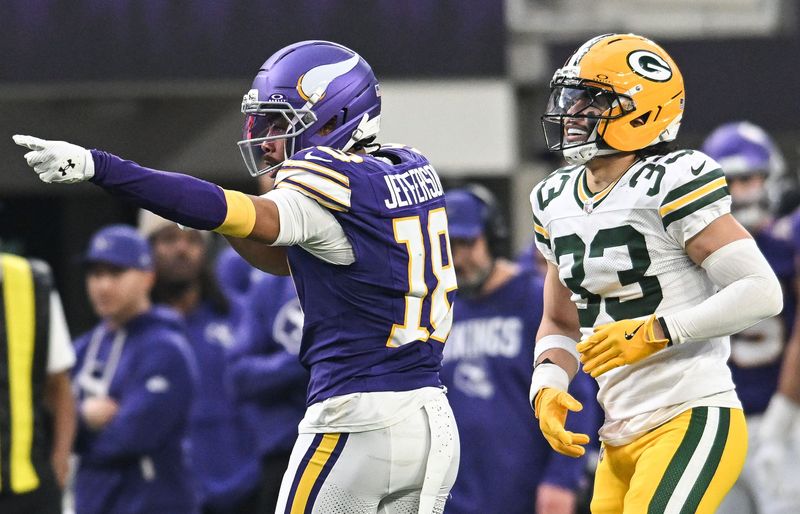 Jan 4, 2026; Minneapolis, Minnesota, USA; Minnesota Vikings wide receiver Justin Jefferson (18) celebrates after a play in front of Green Bay Packers safety Evan Williams (33) during the second quarter at U.S. Bank Stadium. Mandatory Credit: Jeffrey Becker-Imagn Images