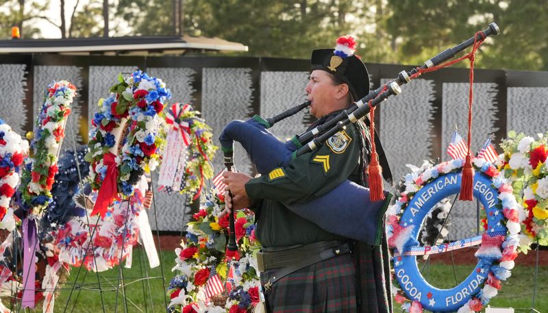 Bagpiper Melody Hunter of the BCSO Honor Guard plays at the wreath-laying and opening ceremony for the 38th annual All Veterans Reunion at Wickham Park in Melbourne.
