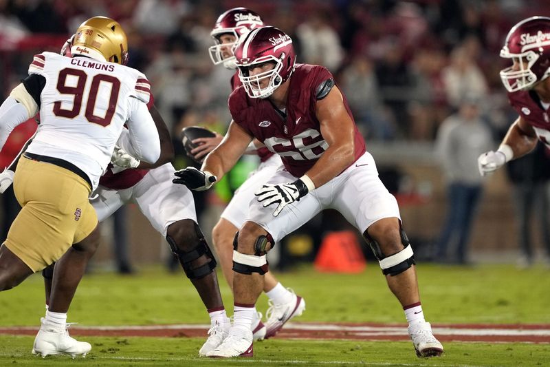 Sep 13, 2025; Stanford, California, USA; Stanford Cardinal offensive lineman Niki Prongos (66) blocks against Boston College Eagles defensive lineman Ty Clemons (90) during the second quarter at Stanford Stadium. Mandatory Credit: Darren Yamashita-Imagn Images