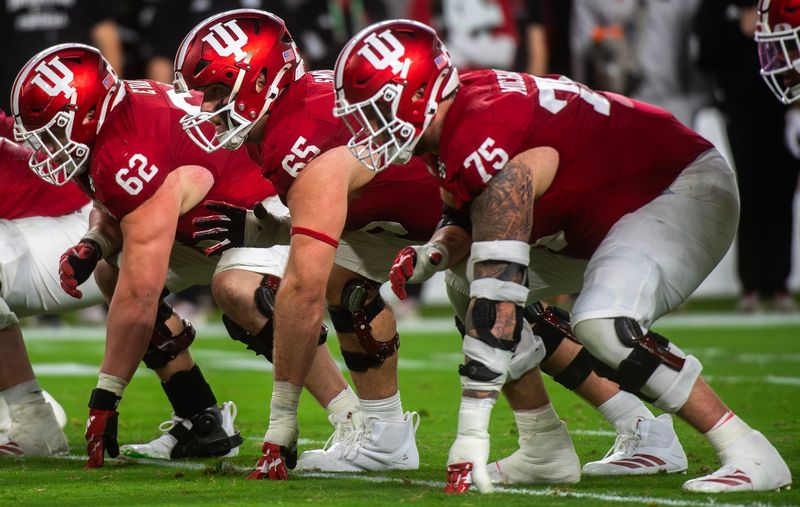 Indiana's Drew Evans (62), Carter Smith (65) and Zen Michalski (75) prepare for a snap during the College Football Playoff National Championship college football game at Hard Rock Stadium in Miami Gardens on Monday, Jan. 19, 2026.