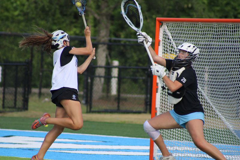Ponte Vedra's Shelby Pare (12) takes a shot on the net defended by goalie Lexie Rupp at high school girls lacrosse practice on May 4, 2026. [Clayton Freeman/Florida Times-Union]
