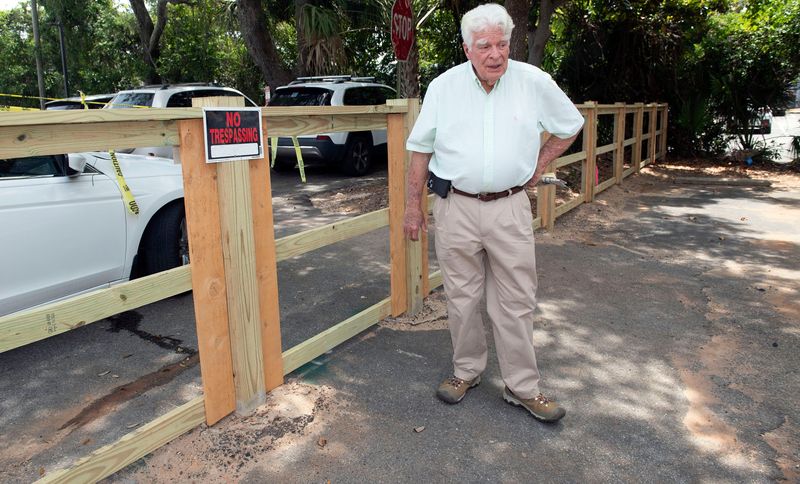 Gulf Breeze property owner Christopher Green has come under fire after building a fence along his property line and denying access to a popular alternative route to the Harbourtown shops. Green began building the fence in late April, but as of May 5, 2026, City of Gulf Breeze officials ordered him to stop construction.
