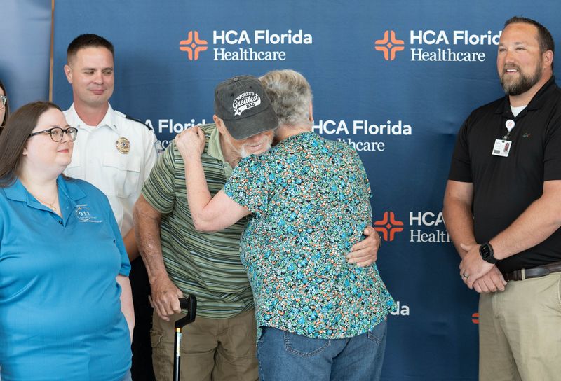 David Wickline, gets a hug from his wife Louella during a gathering at HCA Florida West Hospital in Pensacola on May 5, 2026. Hospital staff and first responders worked together to help save David’s life when he recently collapsed in his home due to a cardiac event.