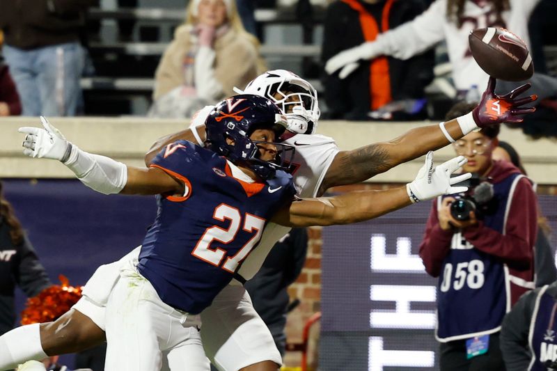 Nov 29, 2025; Charlottesville, Virginia, USA; Virginia Tech Hokies tight end Ja'Ricous Hairston (13) attempts to catch a pass as Virginia Cavaliers safety Devin Neal (27) defendds in the first quarter at Scott Stadium. Mandatory Credit: Geoff Burke-Imagn Images