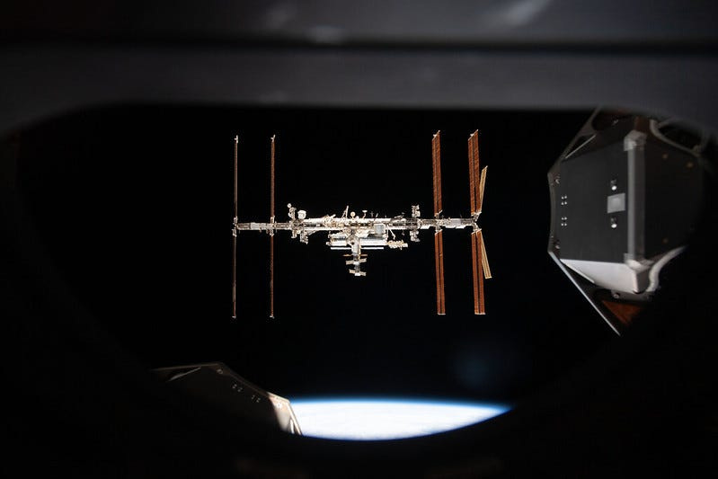 The International Space Station is pictured from inside a window aboard the SpaceX Crew Dragon Endeavour during a fly around of the orbiting lab that took place following its undocking from the Harmony module’s space-facing port on Nov. 8, 2021.