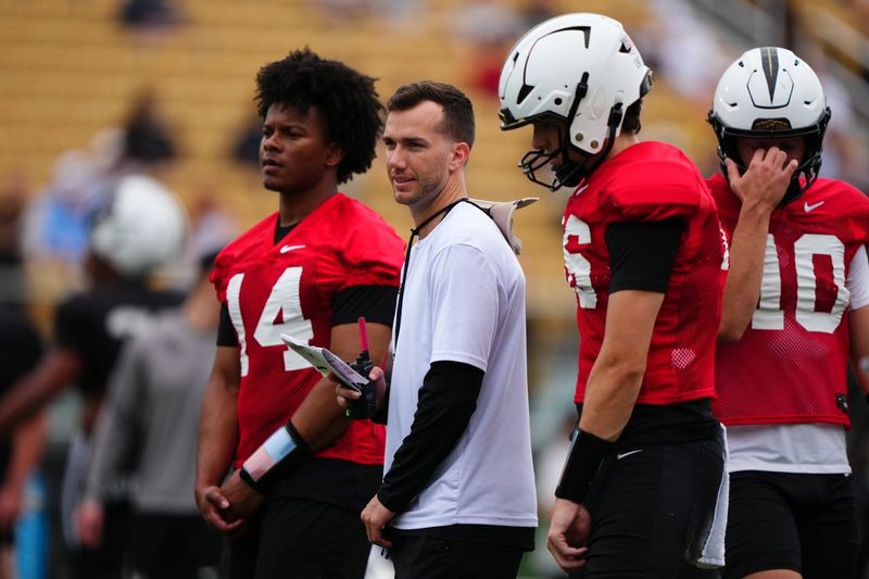 UCF quarterback Alonza Barnett (14) stands next to position coach McKenzie Milton during the team's spring practice at the Acrisure Bounce House, May 2, 2026.