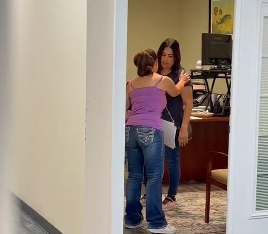 Commissioner Dori Howington, in purple, touches Commissioner Emma Santiago during a confrontation at City Hall.