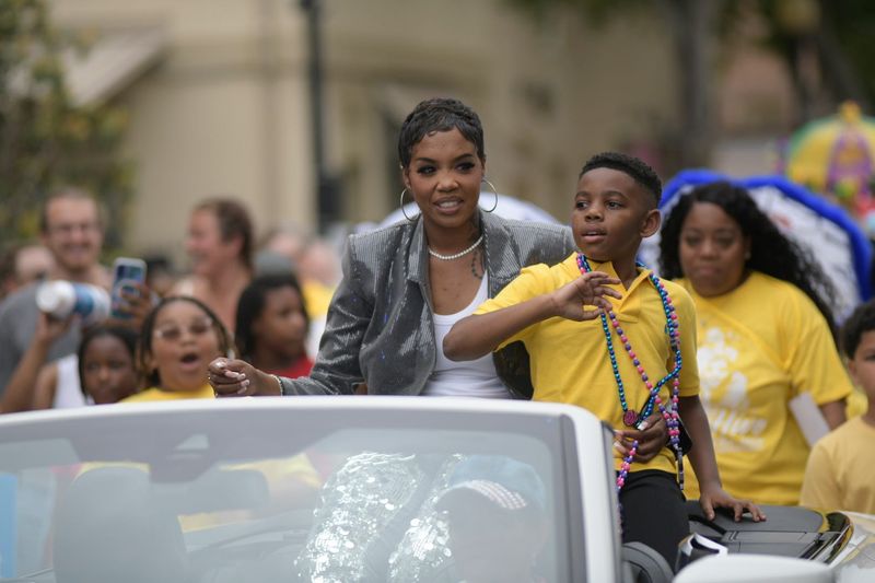 Keyla Richardson and her son, Drew, wave to the crowd during a parade in downtown Pensacola May 6, 2026, celebrating her selection as a top three finalist in Season 24 of American Idol.