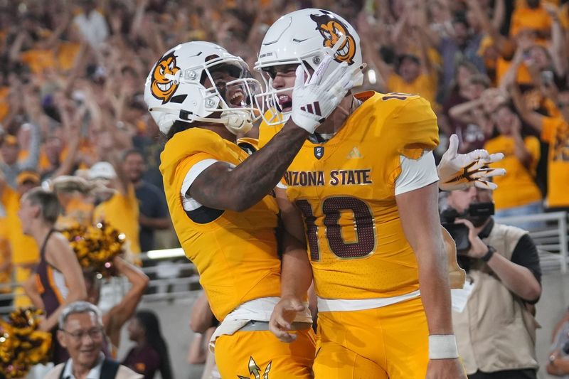 Arizona State quarterback Sam Leavitt (10) celebrates his touchdown run with teammate Jordyn Tyson (0) against the Mississippi State Bulldogs at Mountain America Stadium in Tempe on Sept. 7, 2024.