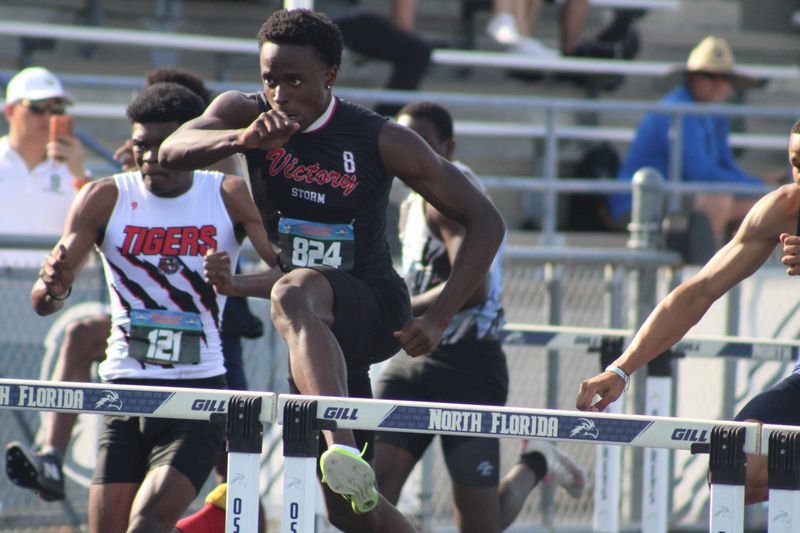 Lakeland Victory Christian's Andrew Morrison (824) clears a hurdle and wins the boys 110 hurdles during the FHSAA Class 1A high school track and field championships in Jacksonville, Florida, on May 6, 2026. [Clayton Freeman/Florida Times-Union]