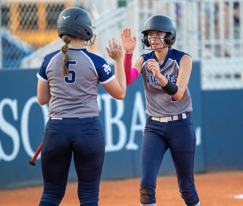McKeel's Isabelle Morrell is congratulated by Kamryn Scobey after scoring a run against Tenoroc on Wednesday night in the Class 3A, Region 3 quarterfinals.