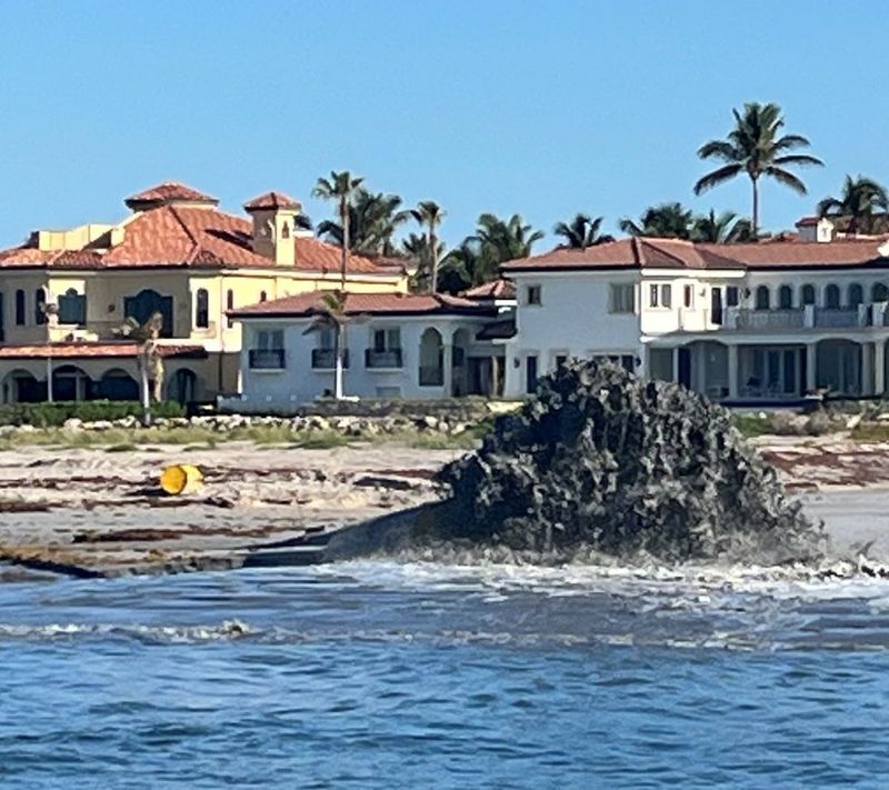 Southwind Construction Corp. of Indiana is pumping dredged sand from Sailfish Point into the St. Lucie River, which critics say is smothering reefs, destroying fish habitat, and flowing over 2 miles south toward the St. Lucie Inlet Preserve State Park's mangrove estuaries and maritime hammocks.