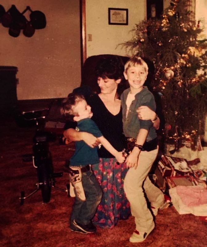 In a photo from the early 1990s, Britt Kennerly visits with her nephews B Moore, left, and Tony Moore, right, during a Christmas trip to Kentucky.