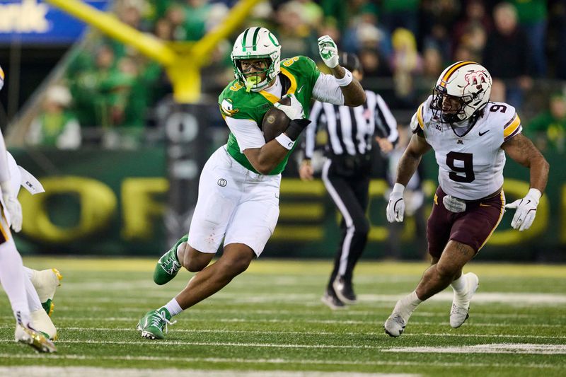 Nov 14, 2025; Eugene, Oregon, USA; Oregon Ducks tight end Jamari Johnson (9) picks up a first down on a pass play during the second half against Minnesota Golden Gophers linebacker Devon Williams (9) at Autzen Stadium. Mandatory Credit: Troy Wayrynen-Imagn Images