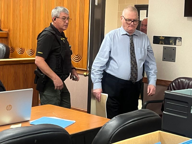 Otto Lenke, 66, of Sebastian, enters a courtroom at the St. Lucie County Courthouse on May 7, 2026, where he’s on trial for capital murder and arson charges in connection with the Feb. 17, 2021 death of Richard Benson, 57, at Fast Frank’s Cycle Concepts, in Fort Pierce.