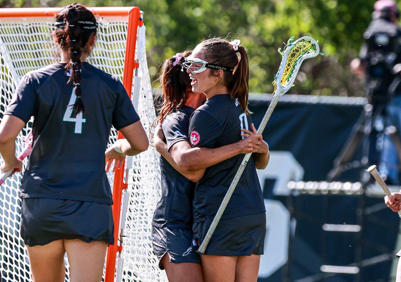 Shae Hagans of the Jacksonville University women's lacrosse team (0) is hugged by a teammate after scoring one of her five goals on May 8 during an NCAA Tournament game against Colorado at Prentup Field in Boulder, Colo.